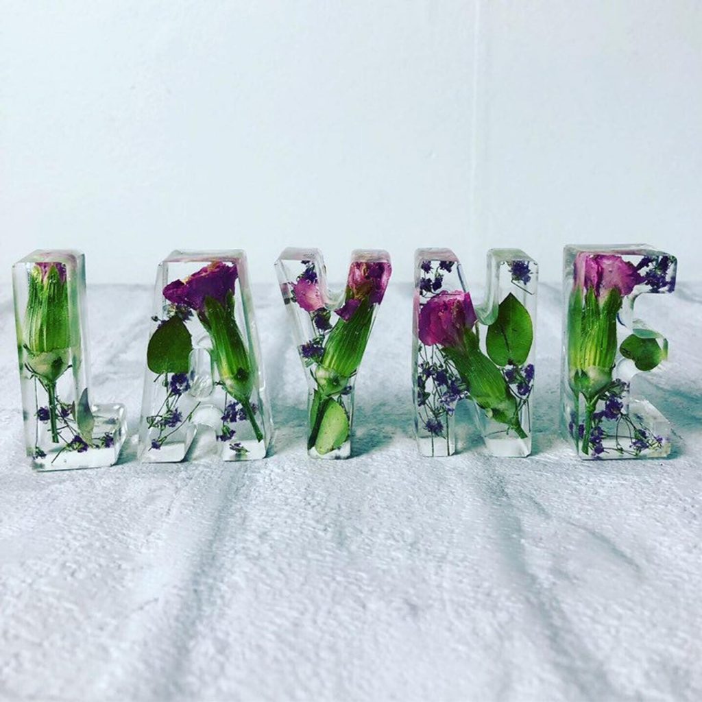 Clear Resin Letters with Purple flowers spells LAYNE